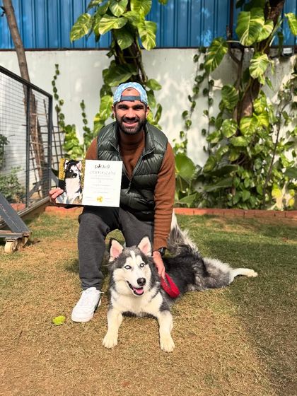 Obi the Husky's graduation photo with his guardian. His journey of building confidence was a beautiful experience.