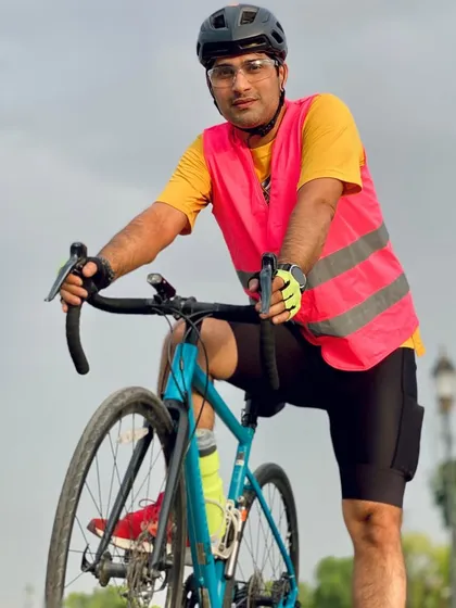 A cyclist in a bright pink safety vest. We emphasize being visible and safe on the road.