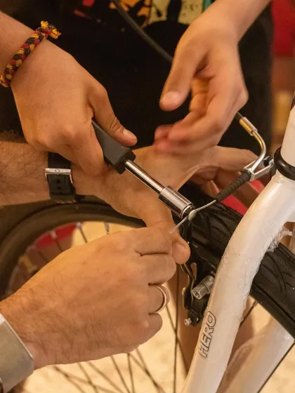 Learning practical life skills is a core part of our philosophy. Here, students work together to understand the mechanics of a bicycle, learning how to adjust brakes and handle tools, which empowers them to fix things themselves.
