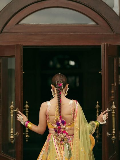A final look at the stunning back details of Vasav's Haldi outfit and her unique pleated parandi hairstyle.