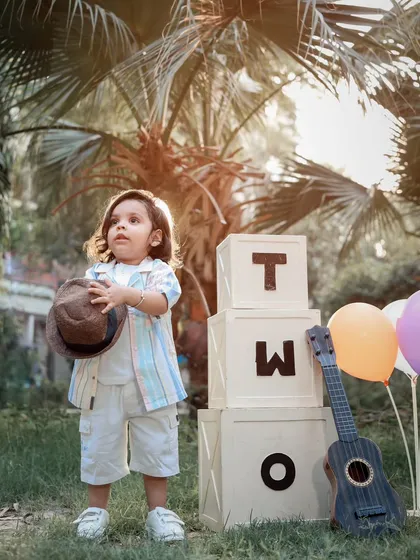 A stylish two-year-old posing during his outdoor birthday photoshoot. We capture both posed and candid moments during our toddler sessions.