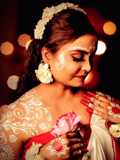 A serene portrait of the Bengali look, with beautiful body art on the shoulder and hands.