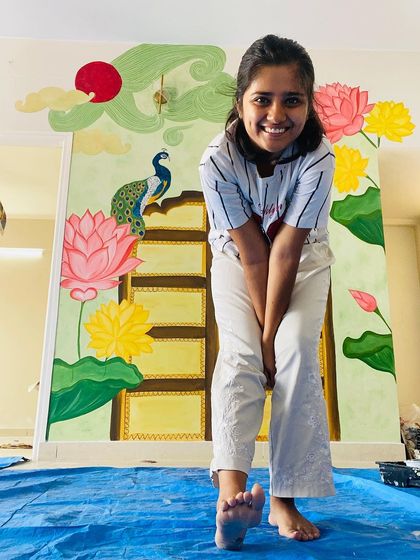 This vibrant, traditional backdrop for a pooja mantap was a wonderful collaboration with our client. It features a painted Jaipur door, Pichwai lotuses, a peacock, and whimsical clouds, all planned in detail.
