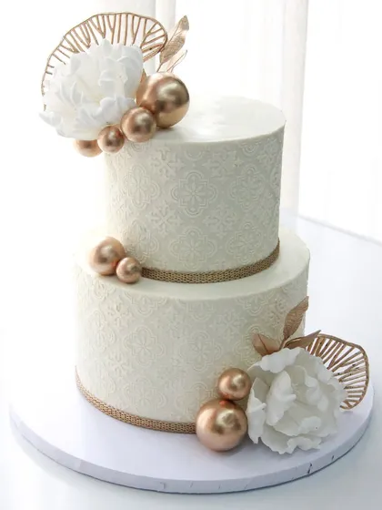 Another view of the elegant white and gold stenciled wedding cake.