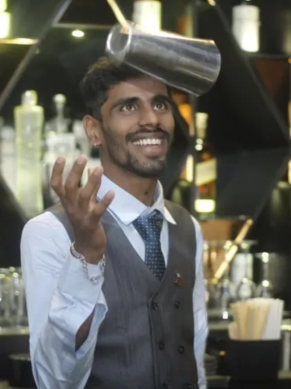 Our bartenders are not just mixologists; they are performers. This shot captures one of our flair bartenders in action, showcasing the skill and energy that makes our bar service a true entertainment feature.
