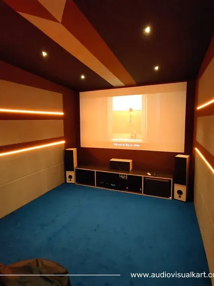 We believe in design that is both simple and intuitive. This room features clean lines, integrated LED accent lighting, and carefully placed speakers for an uncluttered look. The blue carpeting and fabric wall panels also provide essential acoustic absorption.