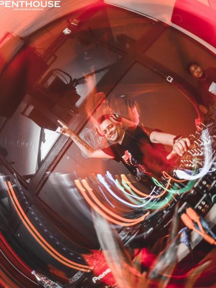 Another energetic, swirling shot from the DJ booth in Siliguri. I'm signaling to the crowd, sharing in the peak energy of the track.