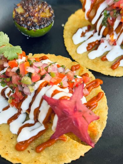 Craving some taco goodness? I've got you covered with these beautiful Avocado Tacos, drizzled with sour cream and a spicy sauce.