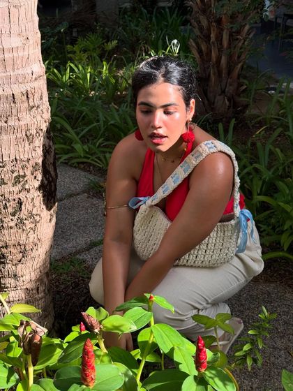 Crouching down to look at the flowers. This shot connects the red of my top to the red flowers on the plant, creating a nice color story.