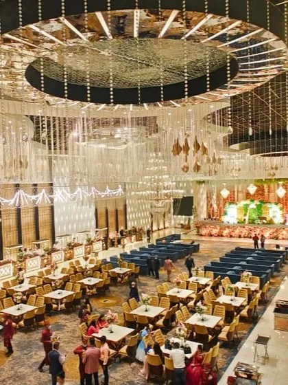 A wide-angle view of a magnificent banquet hall, showcasing its grand scale and intricate ceiling design.