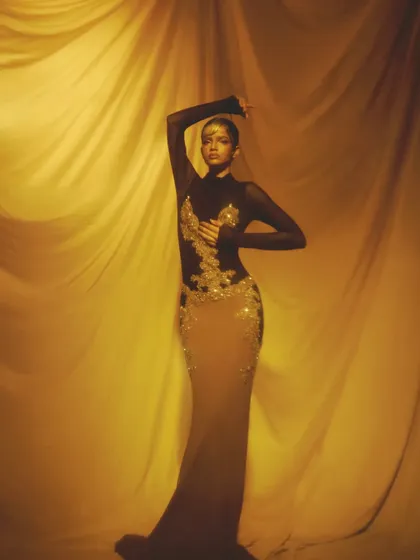 A graceful pose highlighting the intricate gold details on the face and body, creating a look of pure opulence.