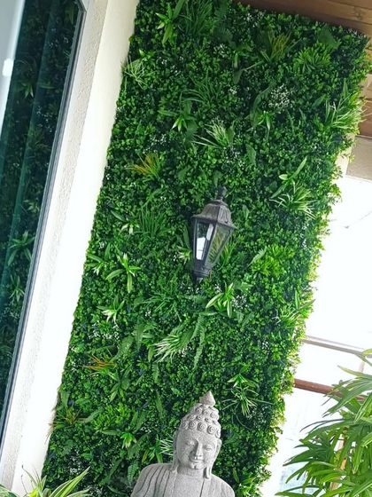 A vertical garden adds a touch of tranquility to this space, complemented by a Buddha statue and a classic lantern. This shows how our installations can enhance a calm, meditative atmosphere.