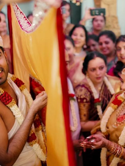 The moment the curtain separating the couple is lowered is filled with anticipation. I focus on the groom's expression as he sees his bride for the first time during the ceremony.