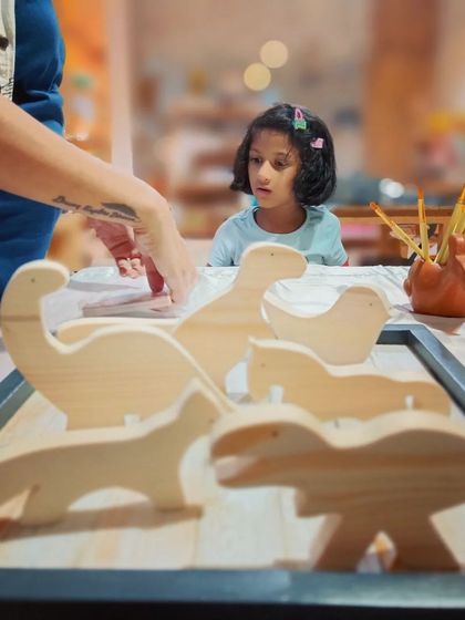 A little artist getting ready to work on our wooden animal cutouts. Our DIY kits are designed to be fun and engaging for kids from ages 2 to 10.