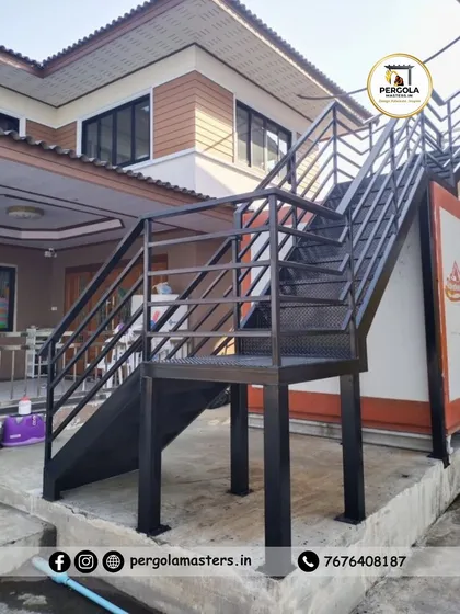 A heavy-duty exterior metal staircase with a landing, providing access to an upper level. The robust construction and practical design make it a perfect functional addition for residential or commercial buildings.