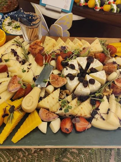 A close-up of an artisanal cheese board from a recent grazing table. I select a variety of high-quality cheeses and pair them with fresh figs, strawberries, and nuts for a perfect balance of flavors and textures.