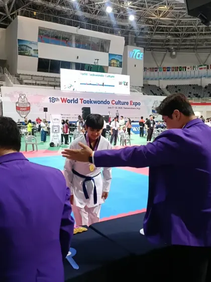 A student receiving his medal from the event officials.