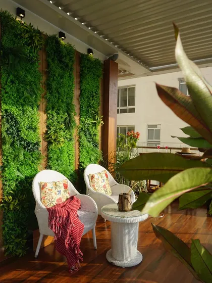 A vertical garden is a fantastic way to add a wall of lush greenery without taking up floor space. We use high-quality artificial green panels to create a maintenance-free, vibrant backdrop that makes any urban balcony feel like a jungle retreat.