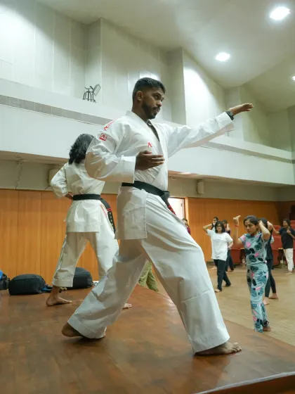 I demonstrate a foundational karate stance during a self-defense workshop. Mastering these core movements is key to building effective self-protection skills.