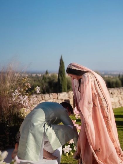 A candid moment of care between the couple during their sun-drenched ceremony in a quaint Italian villa.