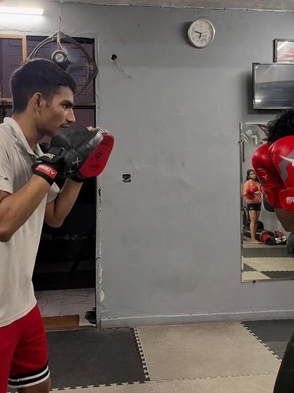 Here, the student is in a defensive posture, ready to throw a counter. Pad work isn't just about offense; it's also about practicing your defensive reactions.