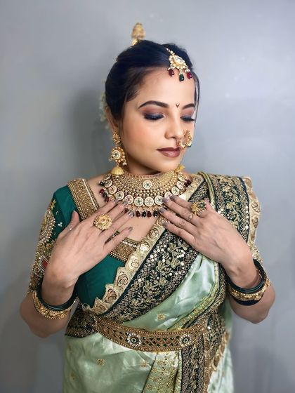 A close-up of the light green Nauvari look, focusing on the jewellery and makeup.