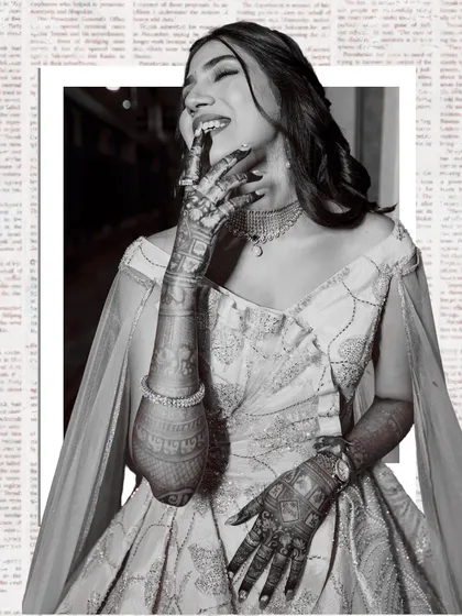 A beautiful black and white portrait of a bride, her face lit with laughter. The newspaper-print background adds a unique, artistic touch to this candid moment.