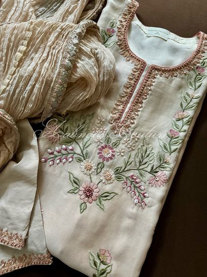 A flat-lay of the suit, showing the beautiful floral embroidery on the yoke.