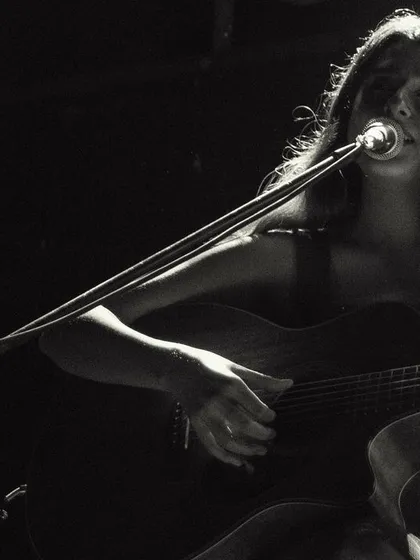A black and white close-up of me singing during a duo performance. The focus is purely on the music and emotion.