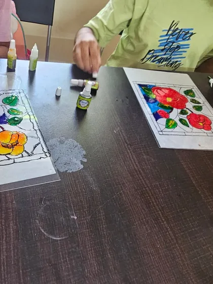 Students engaged in a glass painting session during one of our holiday classes. This is a great way to learn about color and light.