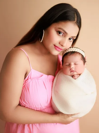 Big love and endless blessings. This portrait of a beautiful mother holding her swaddled baby is filled with so much pride and joy.