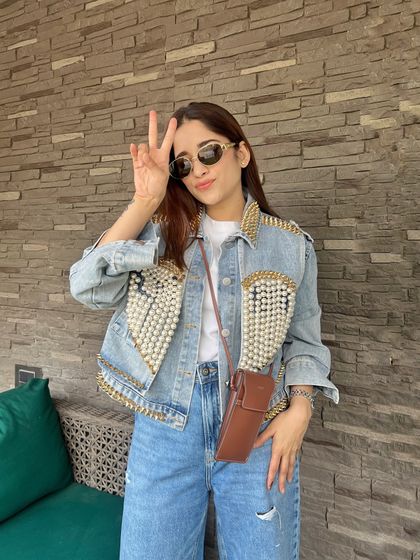 Vibing at the Diljit Dosanjh concert. For a concert look, I love to go for something cool and comfortable, like this denim jacket with pearl and stud details.