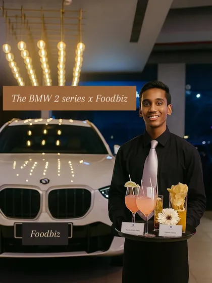 Our professional team ensures flawless service at every event. Here, one of our servers presents curated cocktails and appetizers at the exclusive launch party for the BMW 2 Series, reflecting the brand's sophisticated energy.