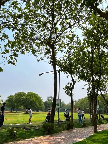 The tree-lined range provides a beautiful and serene environment for a focused practice session.