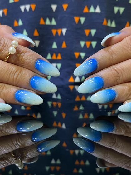 A full view of the frosty blue and white glitter ombre nails, showing the beautiful sparkle.