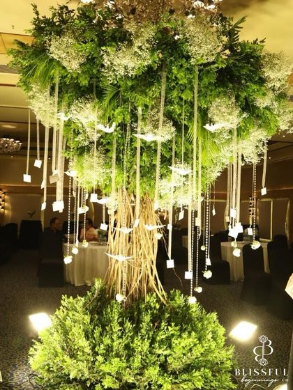 A full view of the Wish Tree, a unique centerpiece we curated for a reception. Made from natural branches and adorned with baby's breath, crystals, and hanging wish cards, it was a magical focal point.