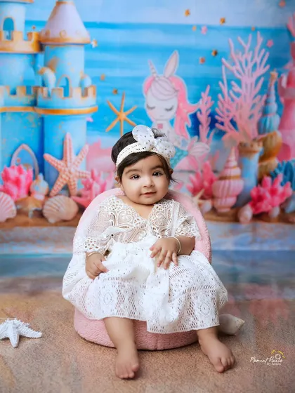 A precious pearl from the ocean. This mermaid-themed shoot with a beautiful underwater castle backdrop is a perfect fantasy for a little one.
