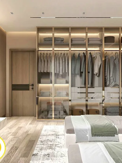 This angle shows the large glass and metal wardrobe, which adds a touch of luxury and provides ample storage. The wooden door adds warmth to the design.