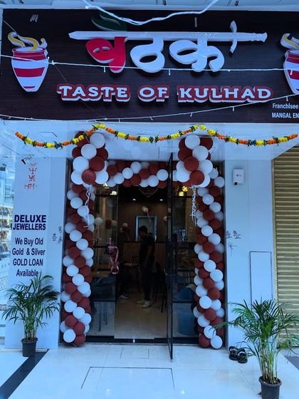 Another angle of the 'Baithaak' cafe opening, highlighting the traditional marigold garland paired with the modern balloon arch.