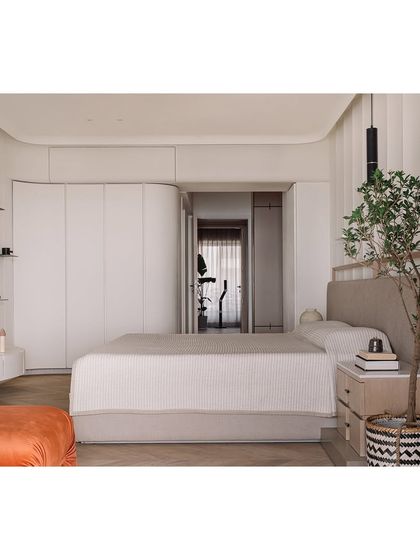 The master bedroom was designed to capture the golden hour sunset. We used beautiful smooth curves in the architecture and cabinetry to create a soft, enveloping feel, making the room a serene retreat that flows seamlessly onto the outdoor deck.