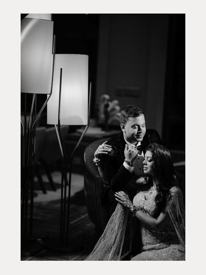 A classic black and white portrait of Aabhaas and Radhika. The intimate pose and soft lighting create a timeless and romantic image from their engagement celebration.