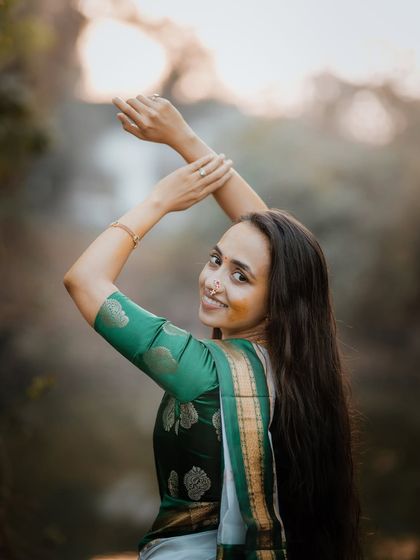 A graceful portrait of a bride posing during her Haldi shoot, her long hair and elegant saree creating a stunning image.