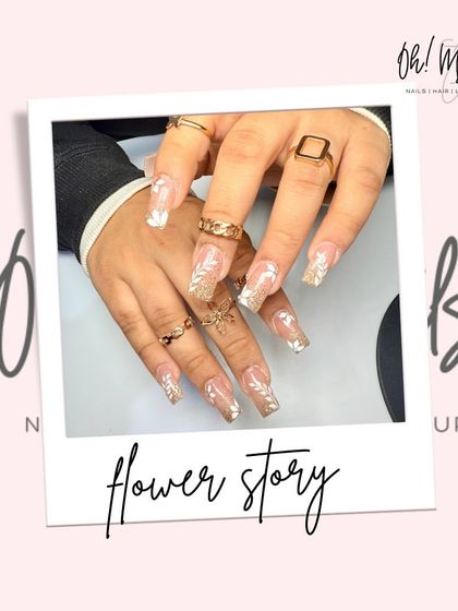 Bloom and sparkle. This dreamy set combines a sheer glitter base with delicate, hand-painted white flowers for a look that is both elegant and whimsical.