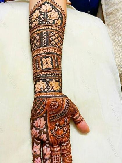 A beautiful arm design featuring bands of floral and geometric patterns, showcasing clean lines and precise execution.