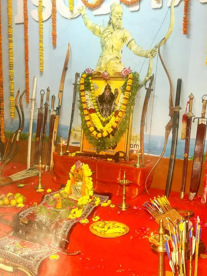 A closer view of our Ayudha Puja altar, where bows and swords are arranged before the image of Lord Parashurama, the ultimate Guru of martial arts.