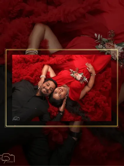A creative, framed perspective of a couple's love. This overhead shot captures an intimate moment, beautifully composed within a golden frame against a backdrop of red tulle.