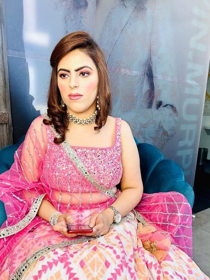 The full look in our salon chair. The soft curls and light makeup create a fresh and youthful vibe, perfect for any celebration.