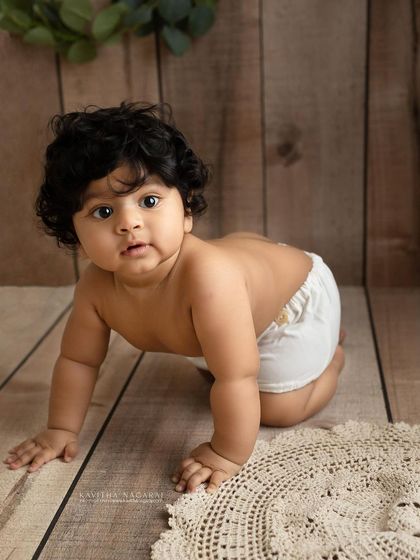 Eight-month-old Viaan exploring during his sitter session. His wide-eyed look and determined crawling pose are a perfect snapshot of this fun and curious age.