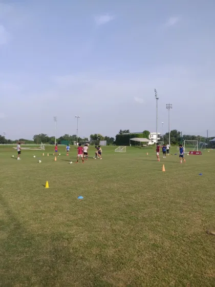A wide shot of our training ground, dotted with cones and players engaged in various drills. This is where the foundation for on-field success is built.