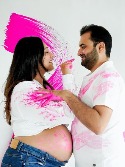 The fun continues in this paint-splattered gender reveal, with the couple sharing a playful moment.